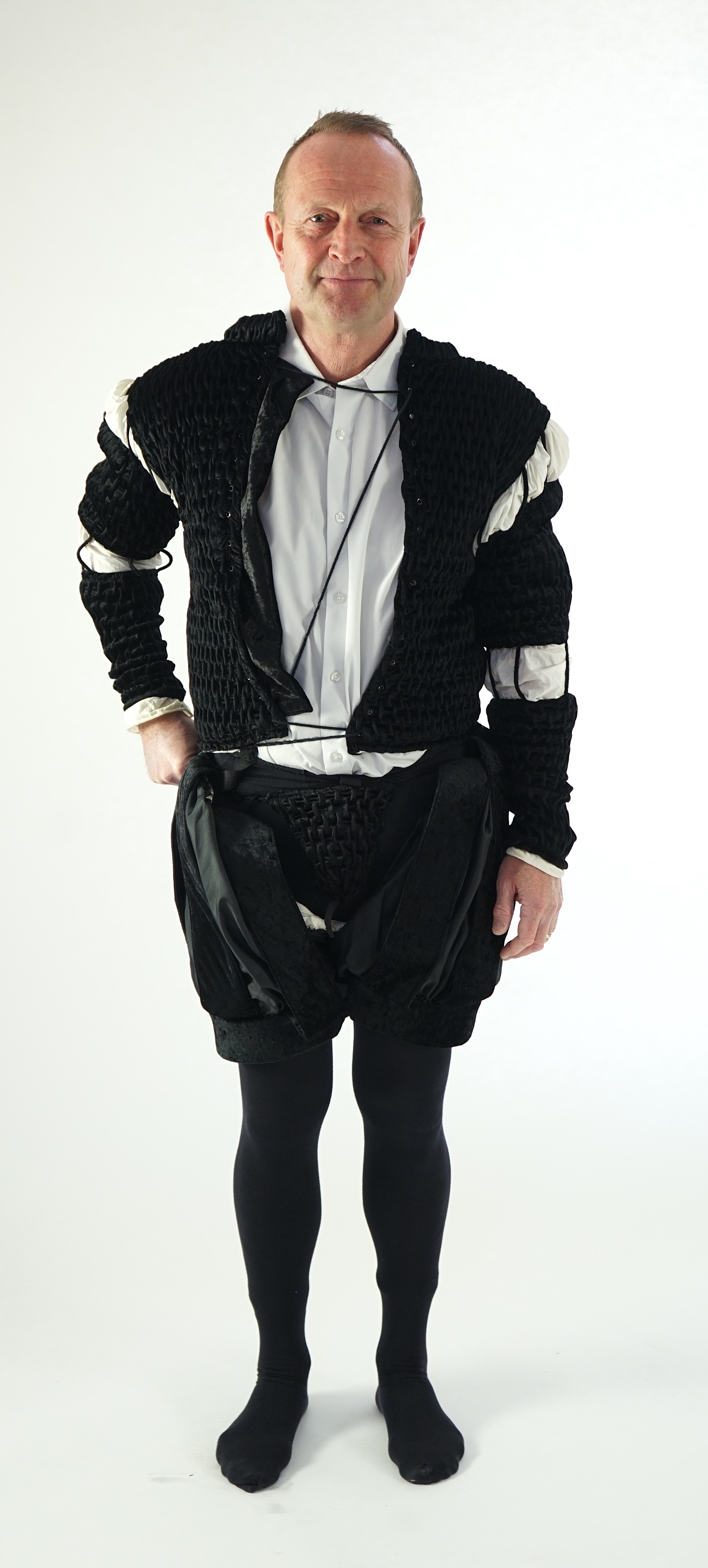 A man's Elizabethan style black smocked velvet and white trim costume, with cod piece and black tights. Ex Royal Opera House Sale.